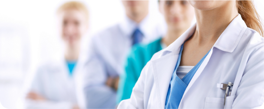 Medical care team in white coats and scrubs